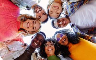 Photo looking up at a circle of friendly faces to illustrate the article Become All Things to All Men